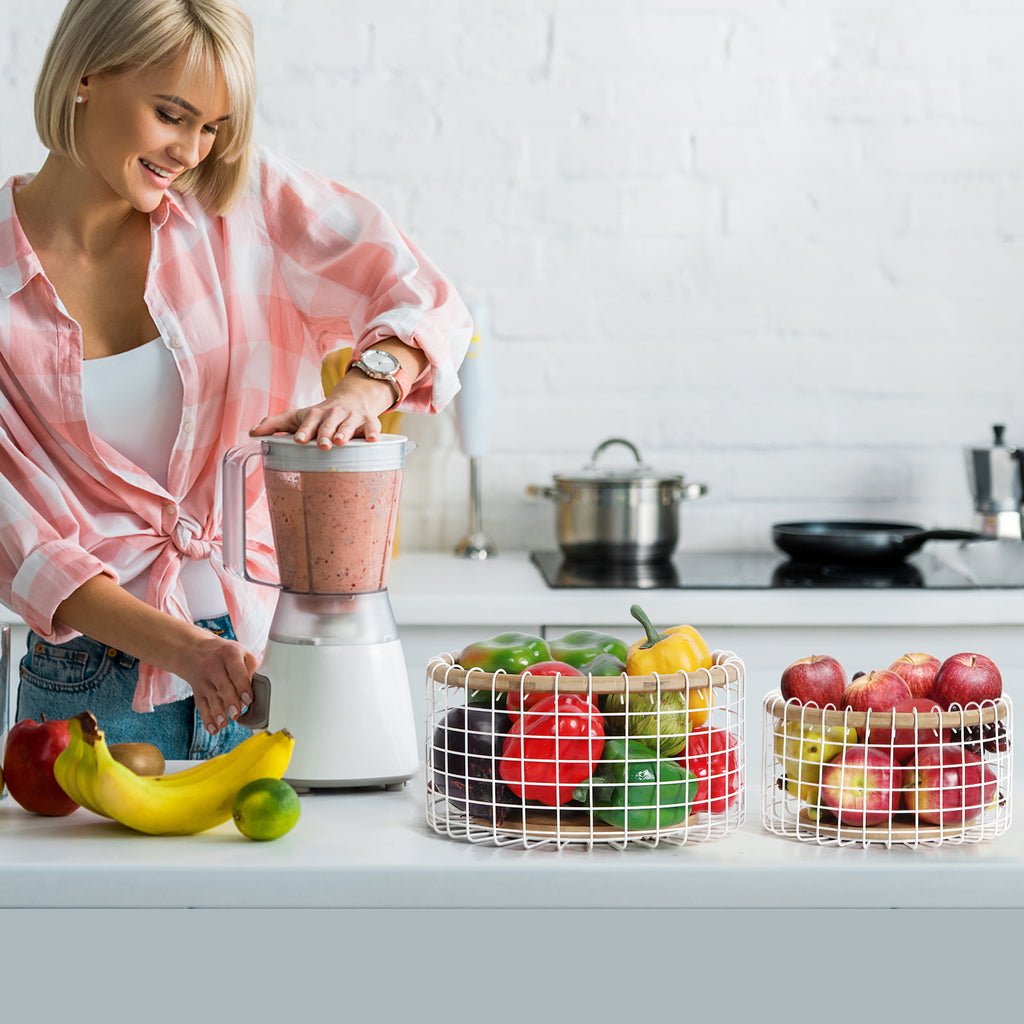 2 Pack Round White Fruit Baskets. They can be placed on dining tables in the living room or kitchen to hold fruits, snacks and other items. Practical and user-friendly, these baskets add a warm daily vibe to your tabletop.